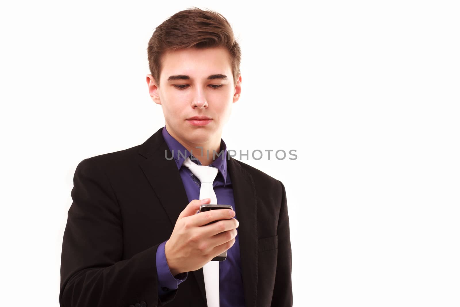 Young businessman seriously
 looking to the phone by DmitryOsipov