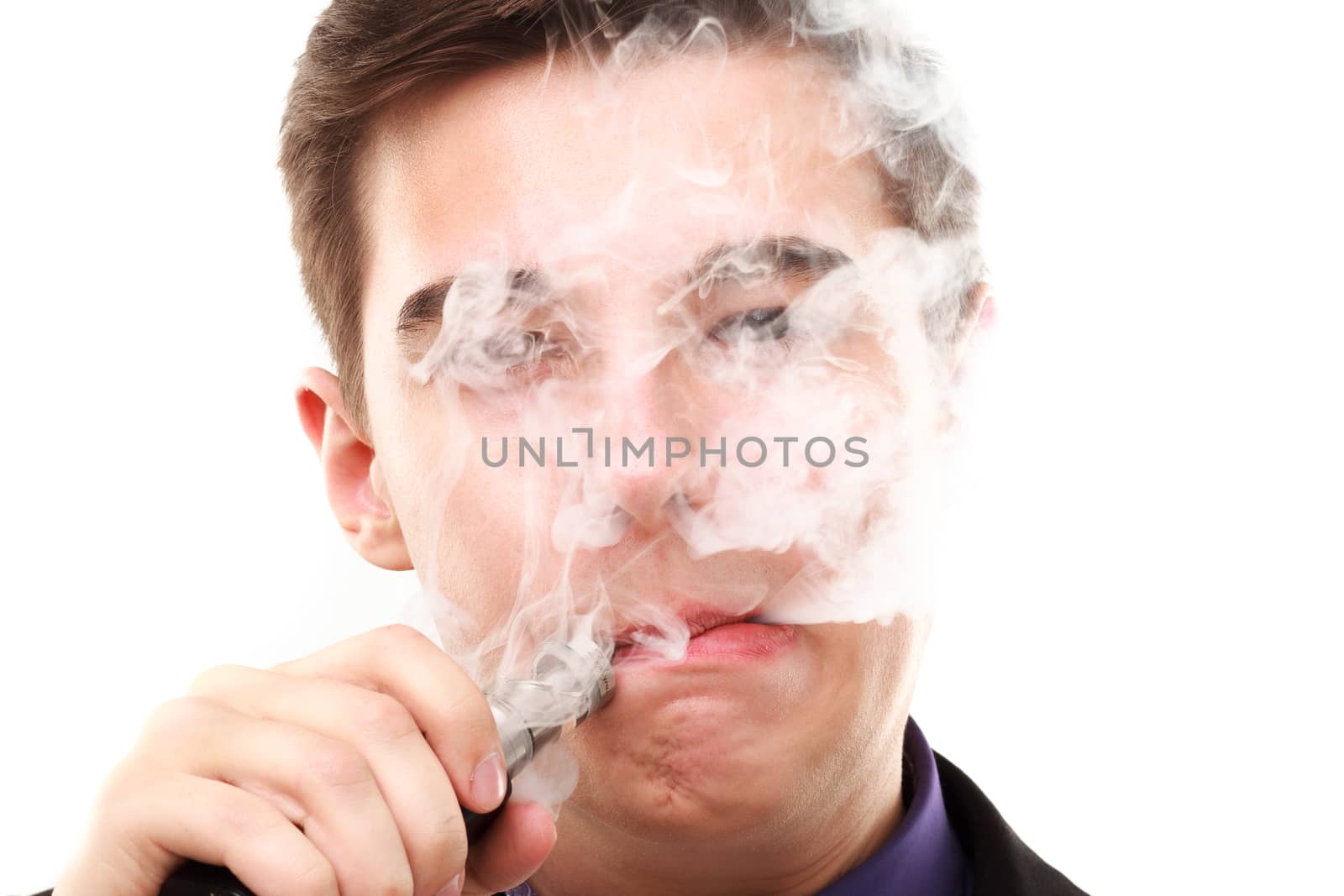 Portrait of a man in suit smoking an e-cigarette isolated on white. Let the steam out of his mouth