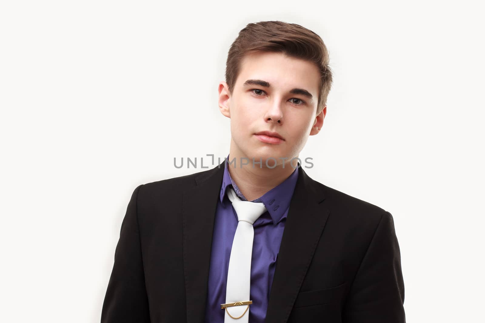 Close-up portrait of young business man wearing suit and tie isolated on white