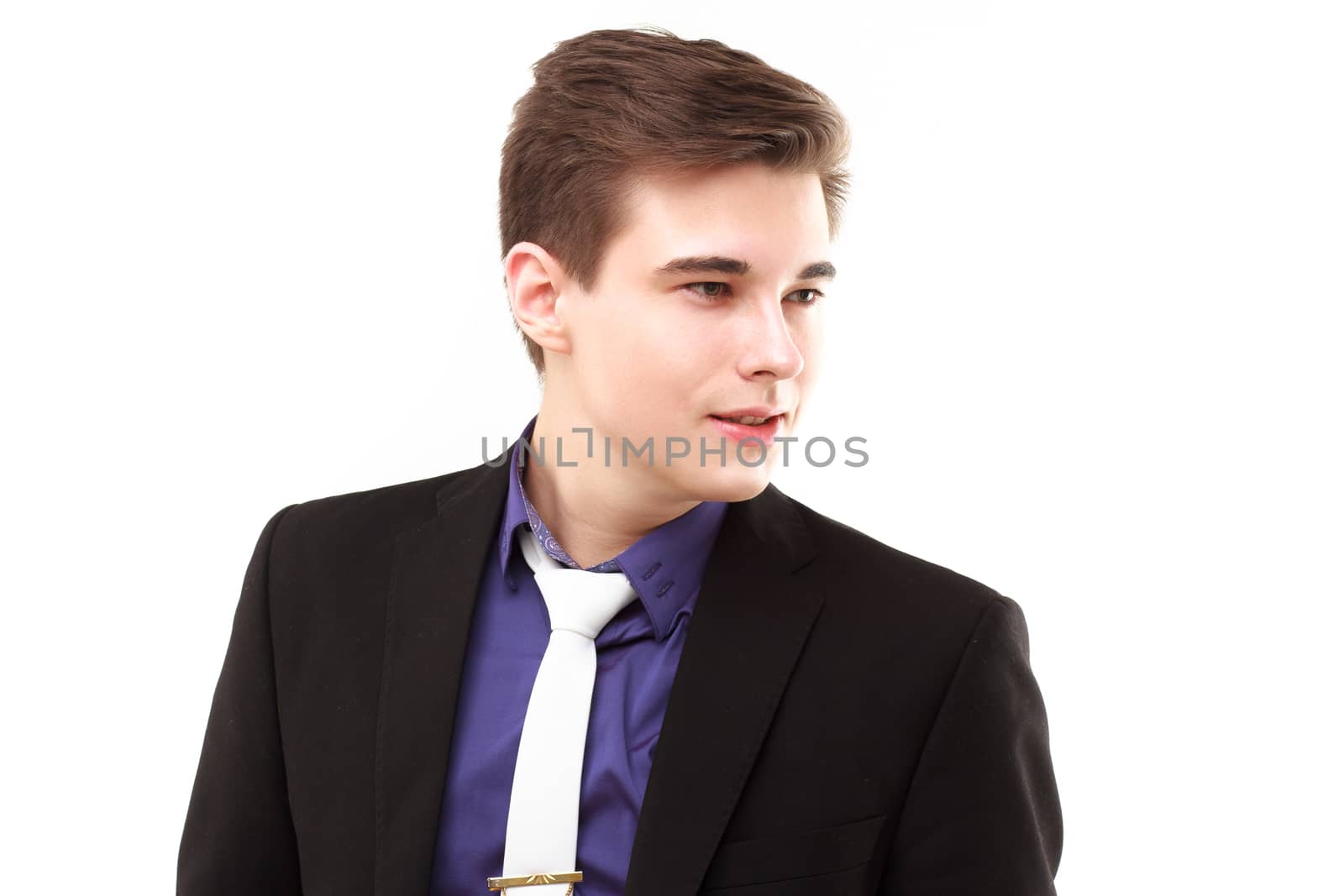 Young business man looking away and smiling by DmitryOsipov