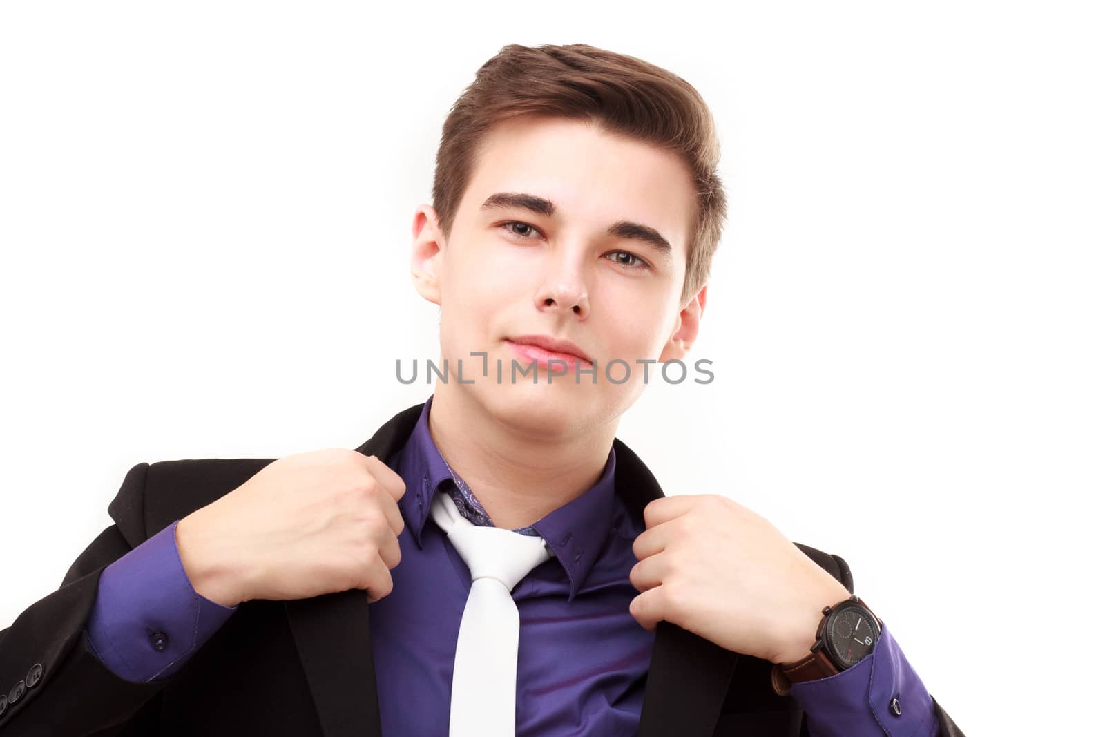 Portrait of an attractive young businessman correcting his jacket isolated on white