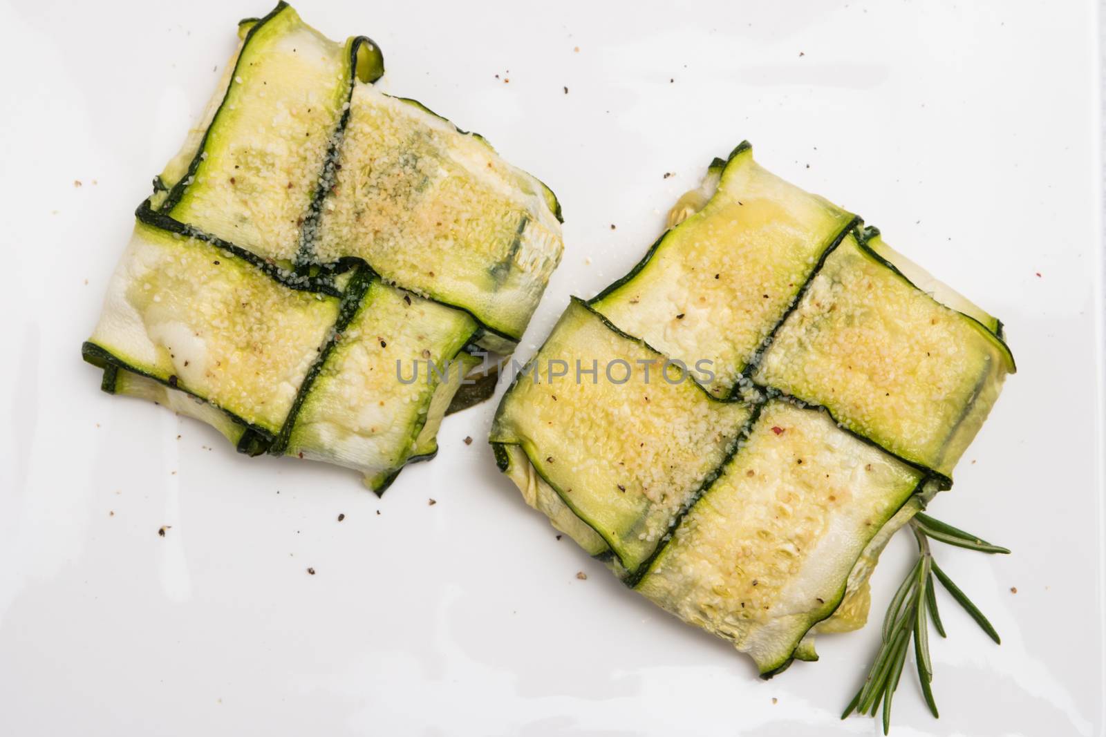 Oven baked courgettes stuffed with cheese, garlic and herbs. Courgette recipe in the oven. Top view with copy space.