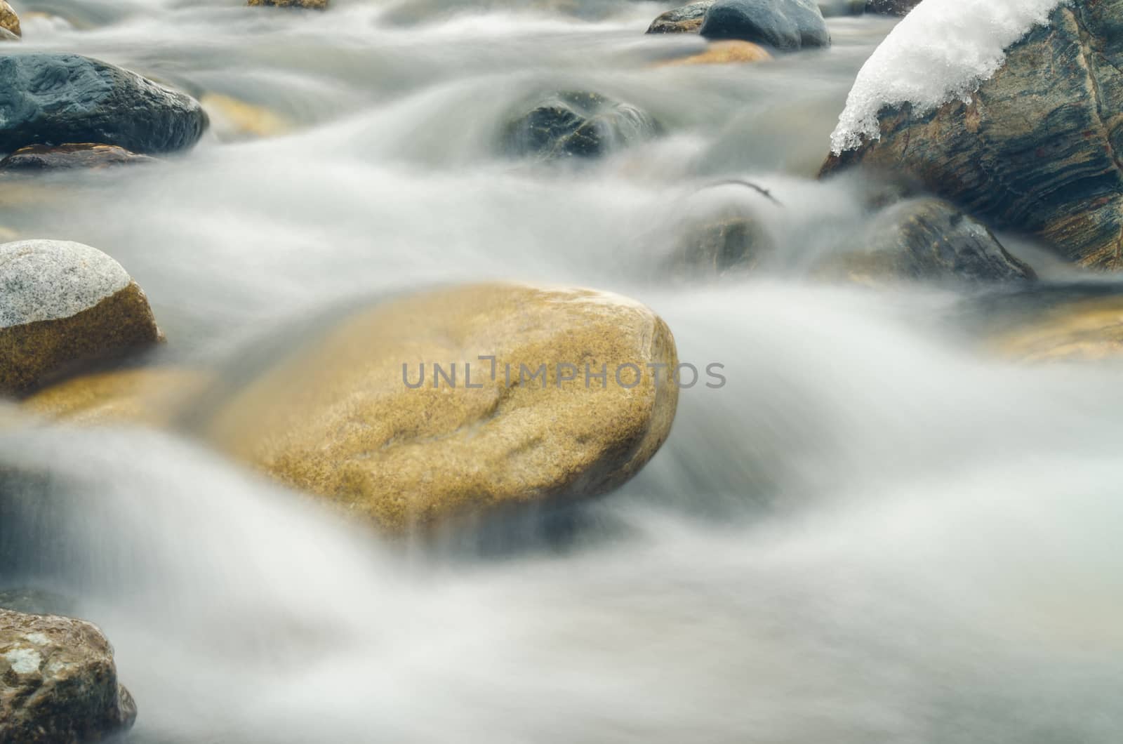 Current between rocks mountain river shot with long exposure by Madhourse