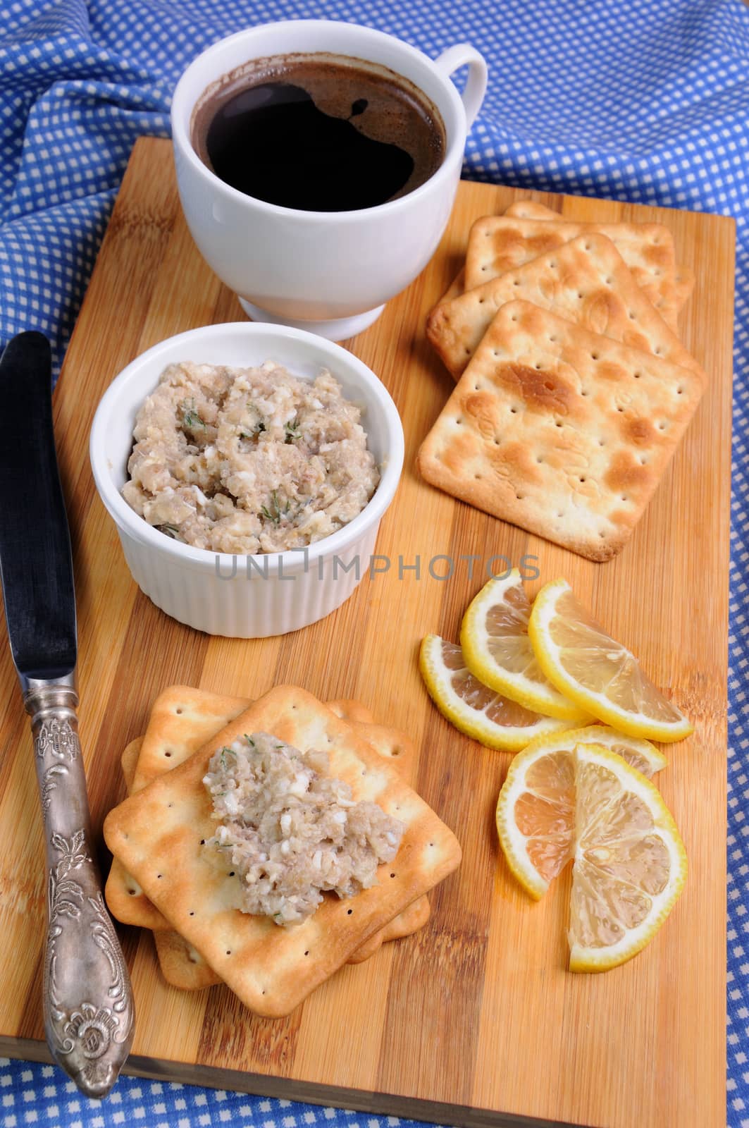 Snack  of fish paste (forshmak) on a cracker with a cup of coffee