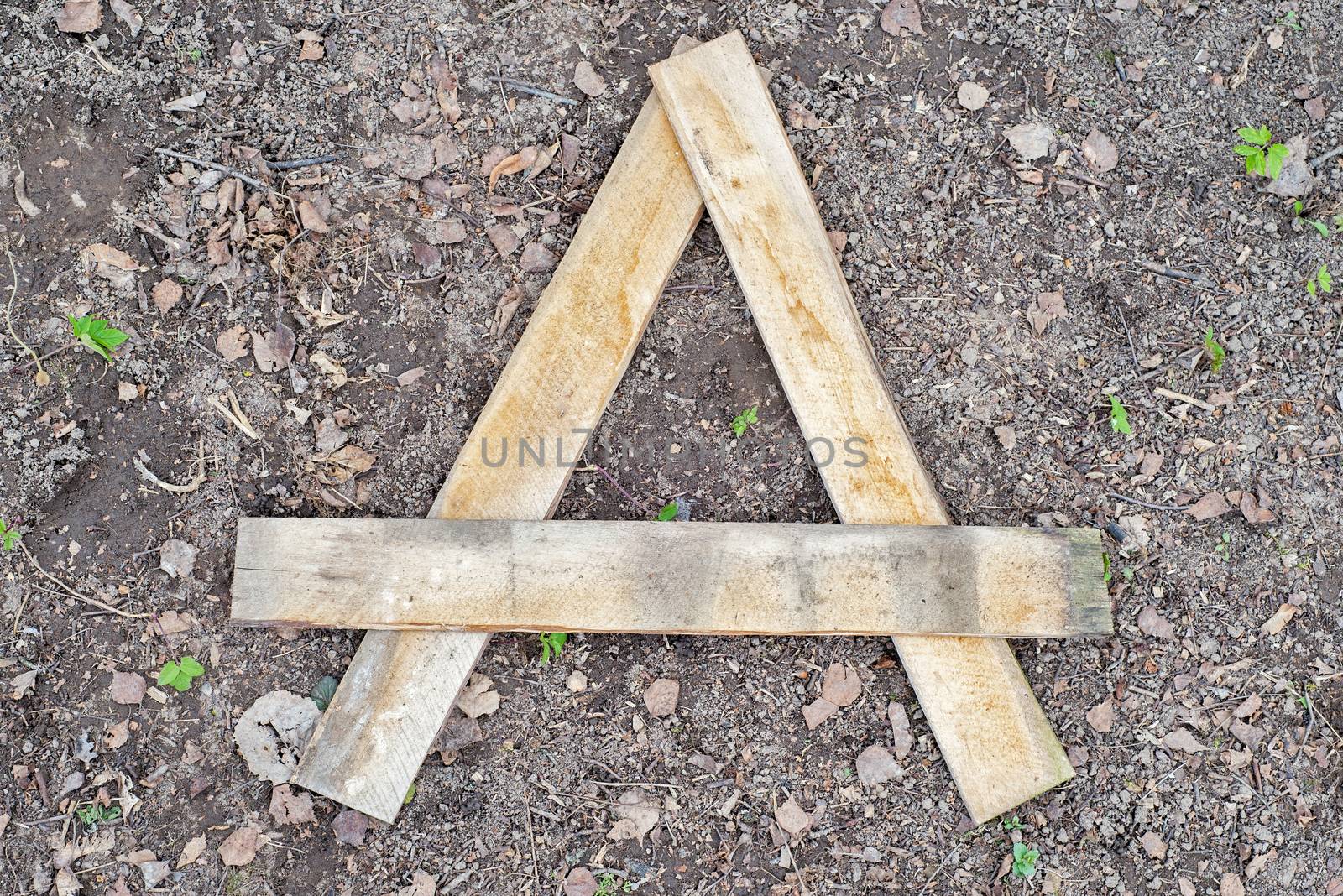 Letter A made of wooden planks on the ground