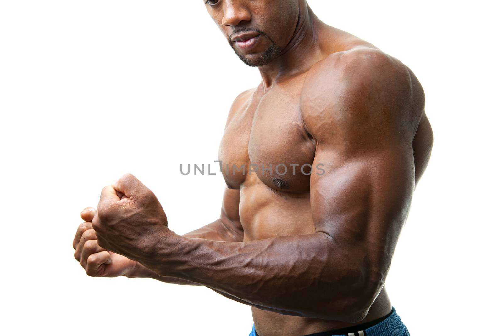 Ripped and muscular martial artist flexing his muscles isolated over a white background. 