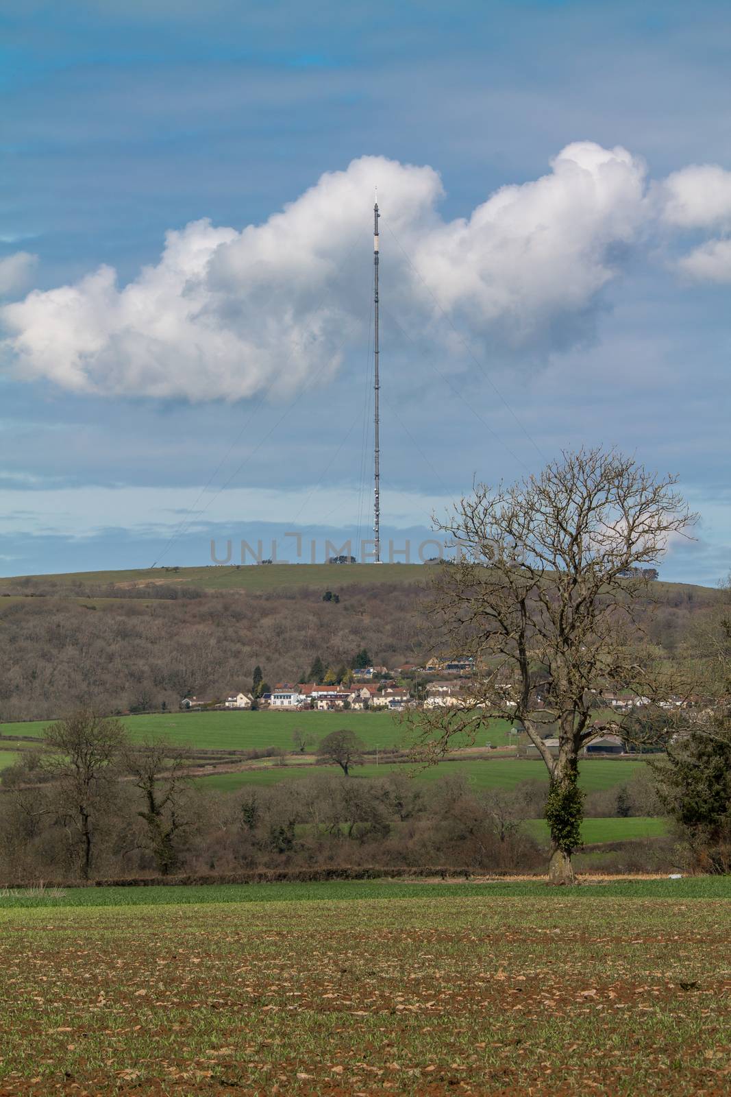 Old analogue TV mast, now used for mobile phone signal, in the middle of a rural setting.
