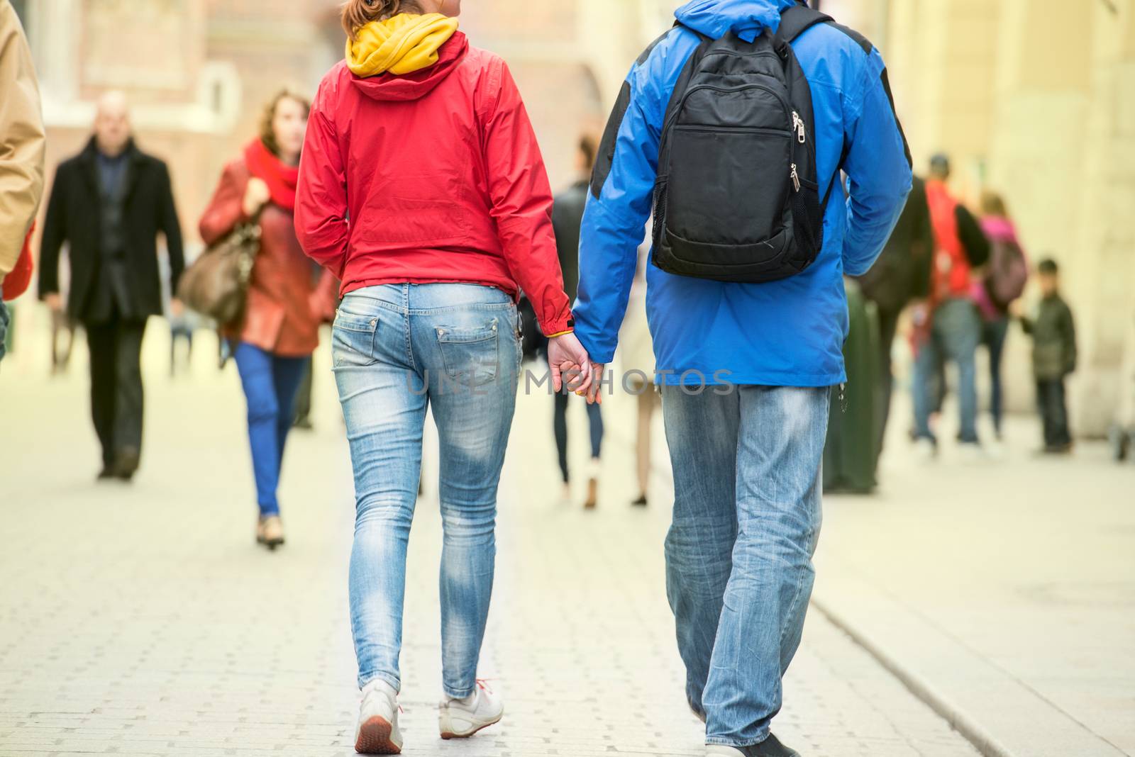 Young couple holding hands on the street