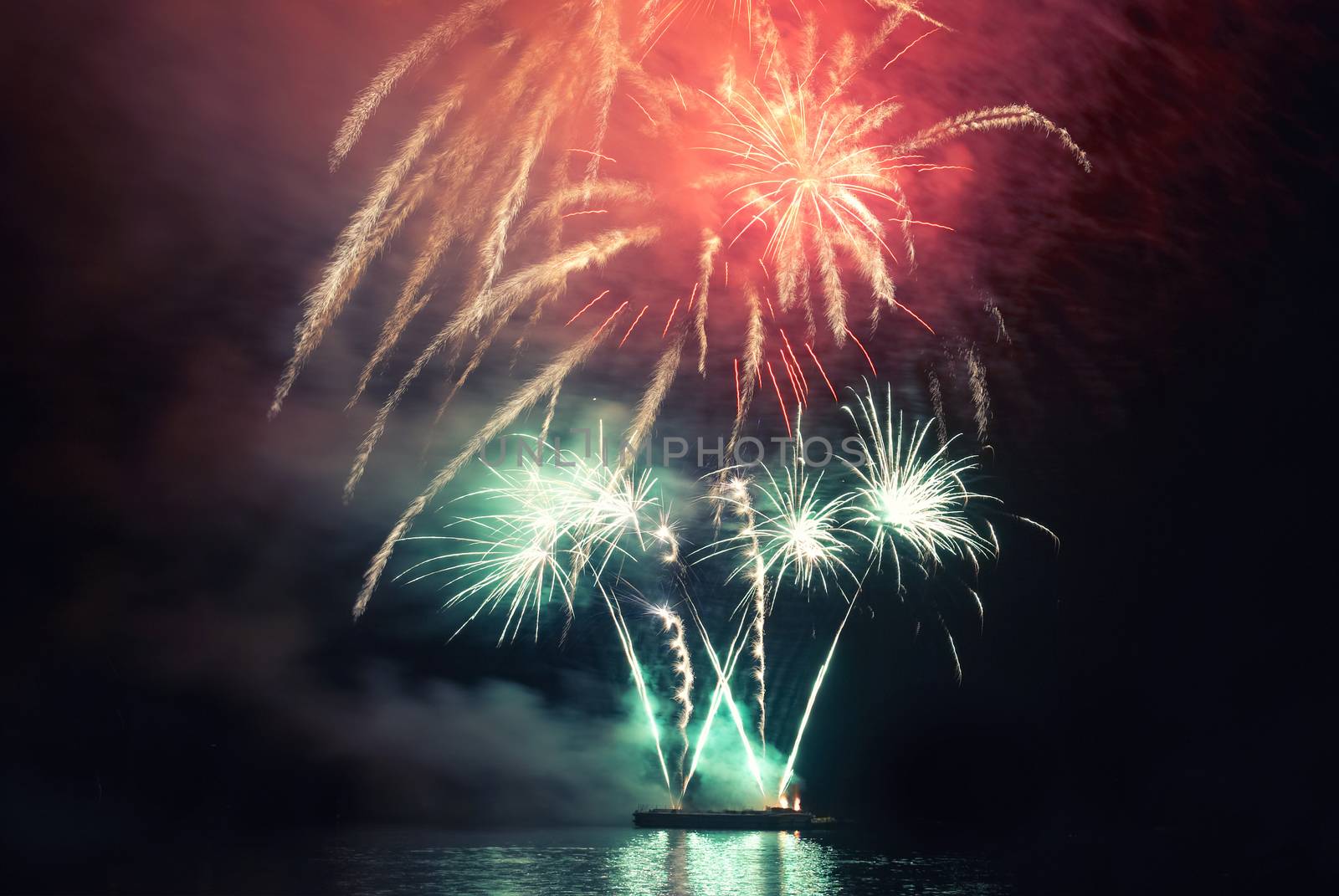 Colorful holiday fireworks on the black sky background.