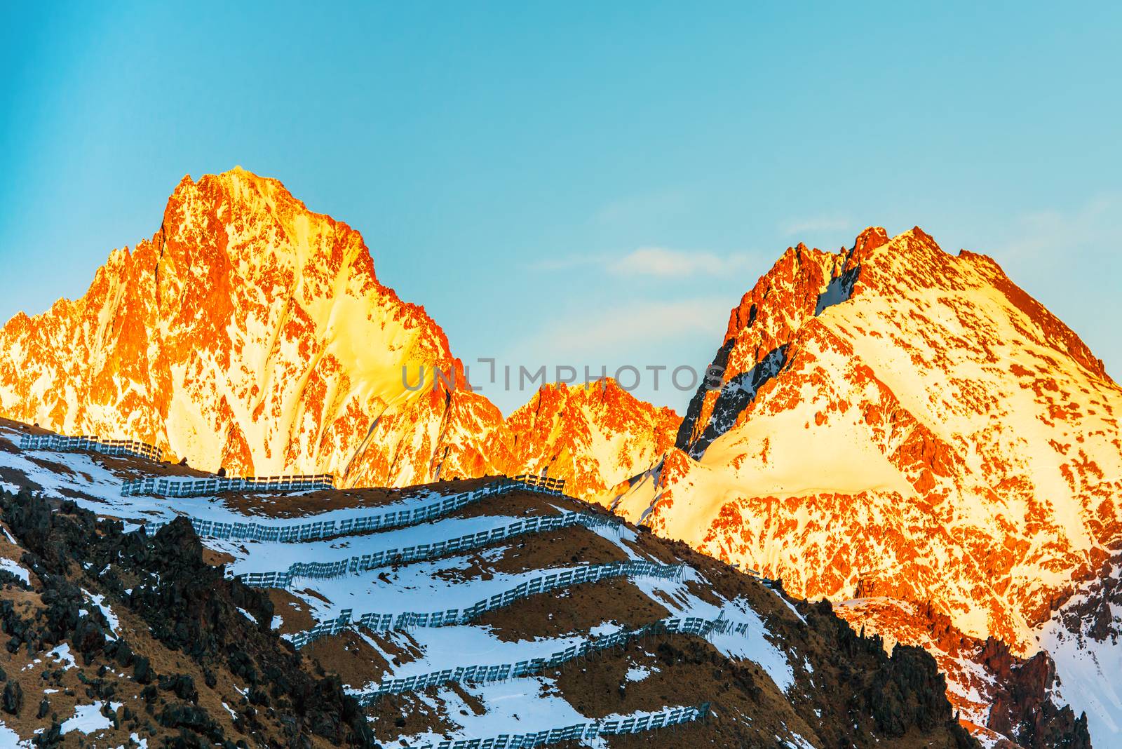 Sunset in mountains covered by snow.