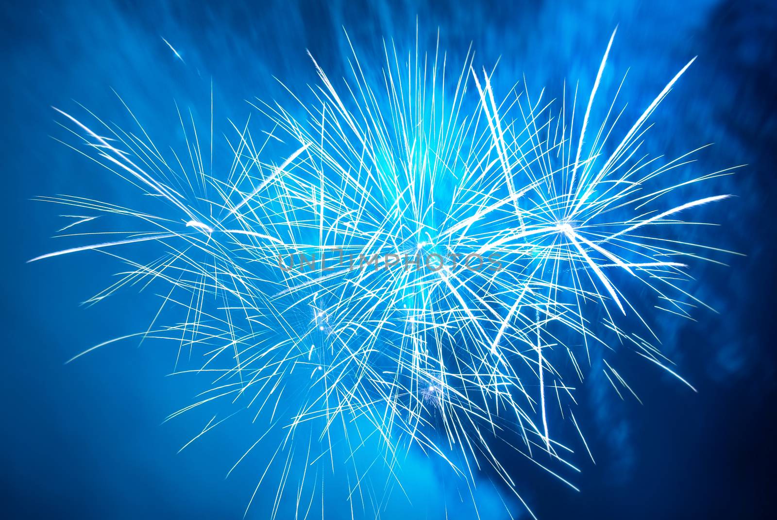 Blue colorful fireworks on the black sky background. Holiday celebration.