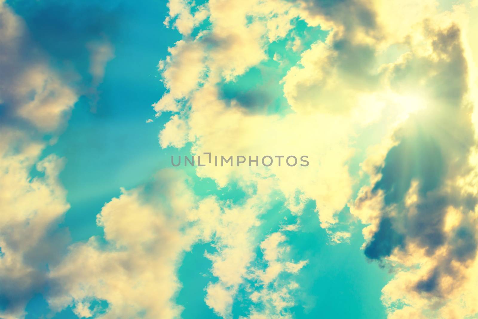 Blue clouds and sky. Natural background with sunbeams, instagram like filter