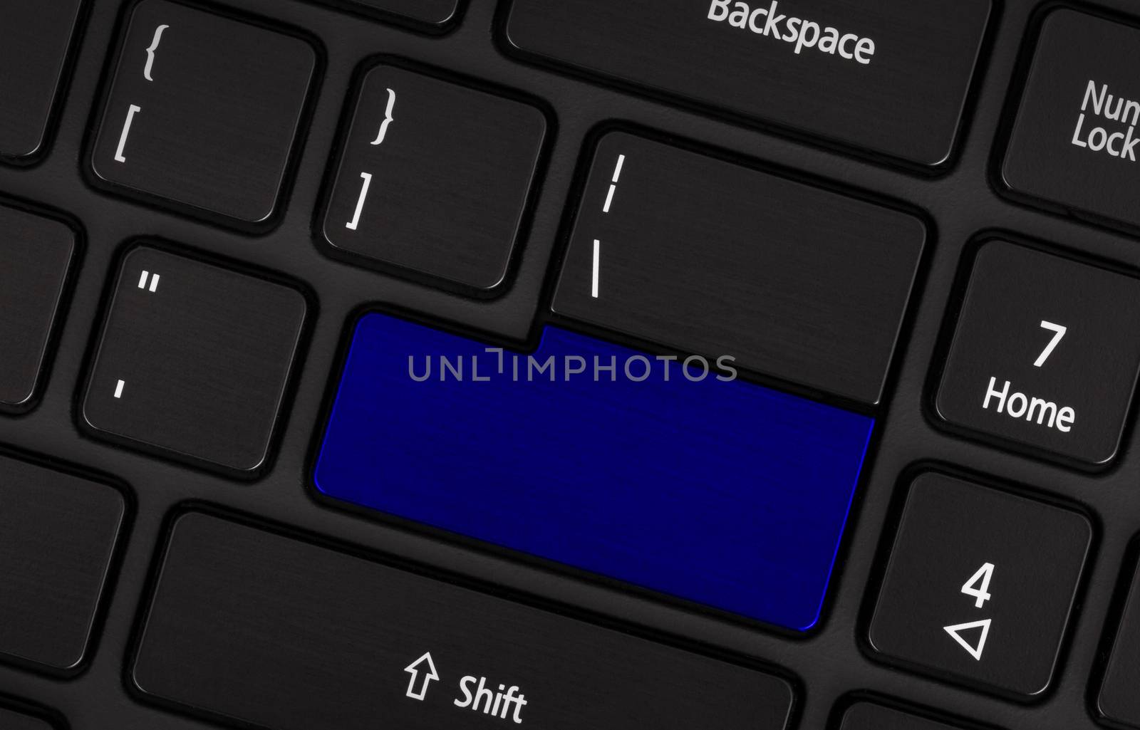 Laptop computer keyboard with blank blue button for text