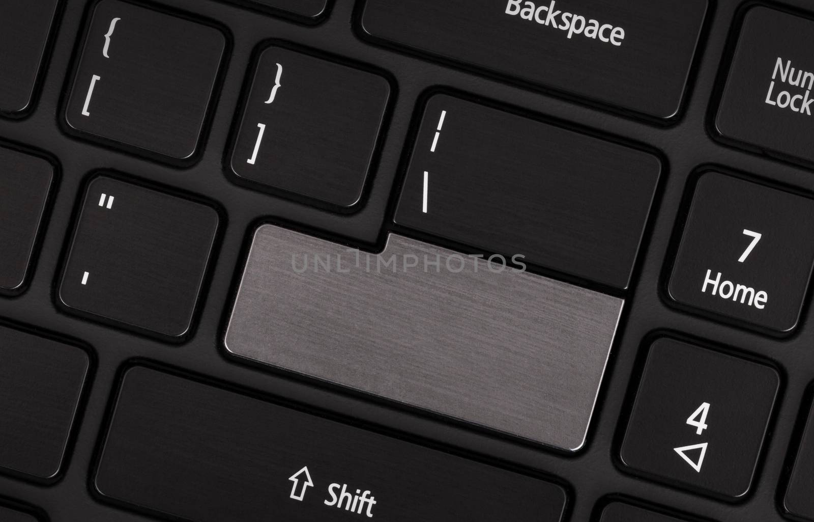 Laptop computer keyboard with blank grey button for text
