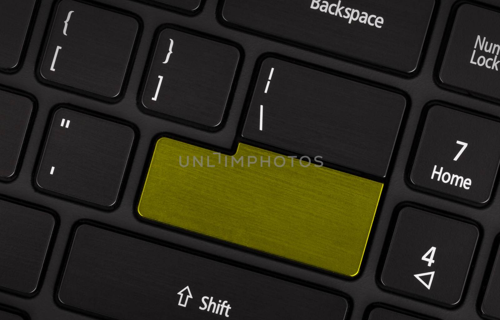 Laptop computer keyboard with blank yellow button for text