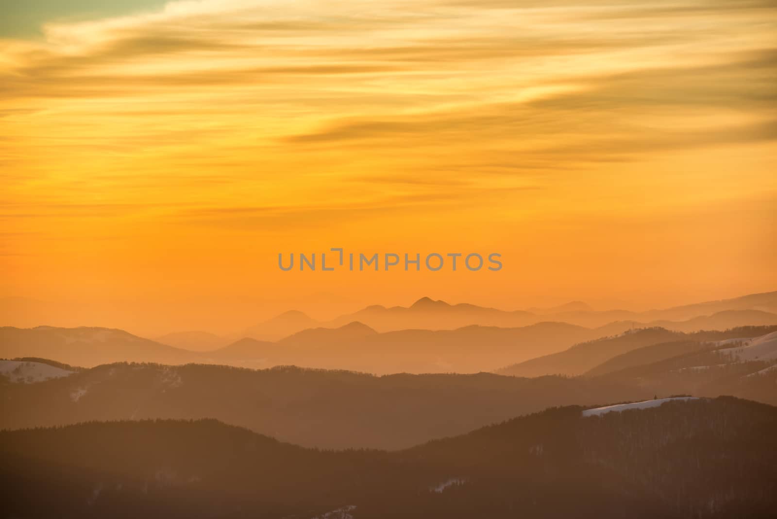 Sunset in winter mountains covered with snow.