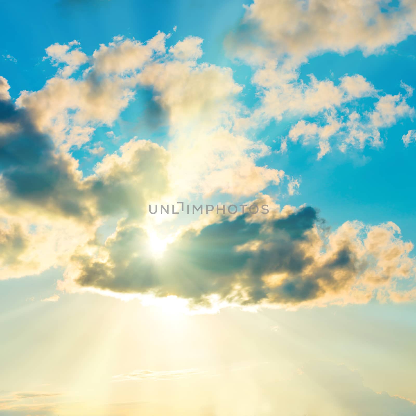 Blue clouds and sky. Natural background with sunbeams