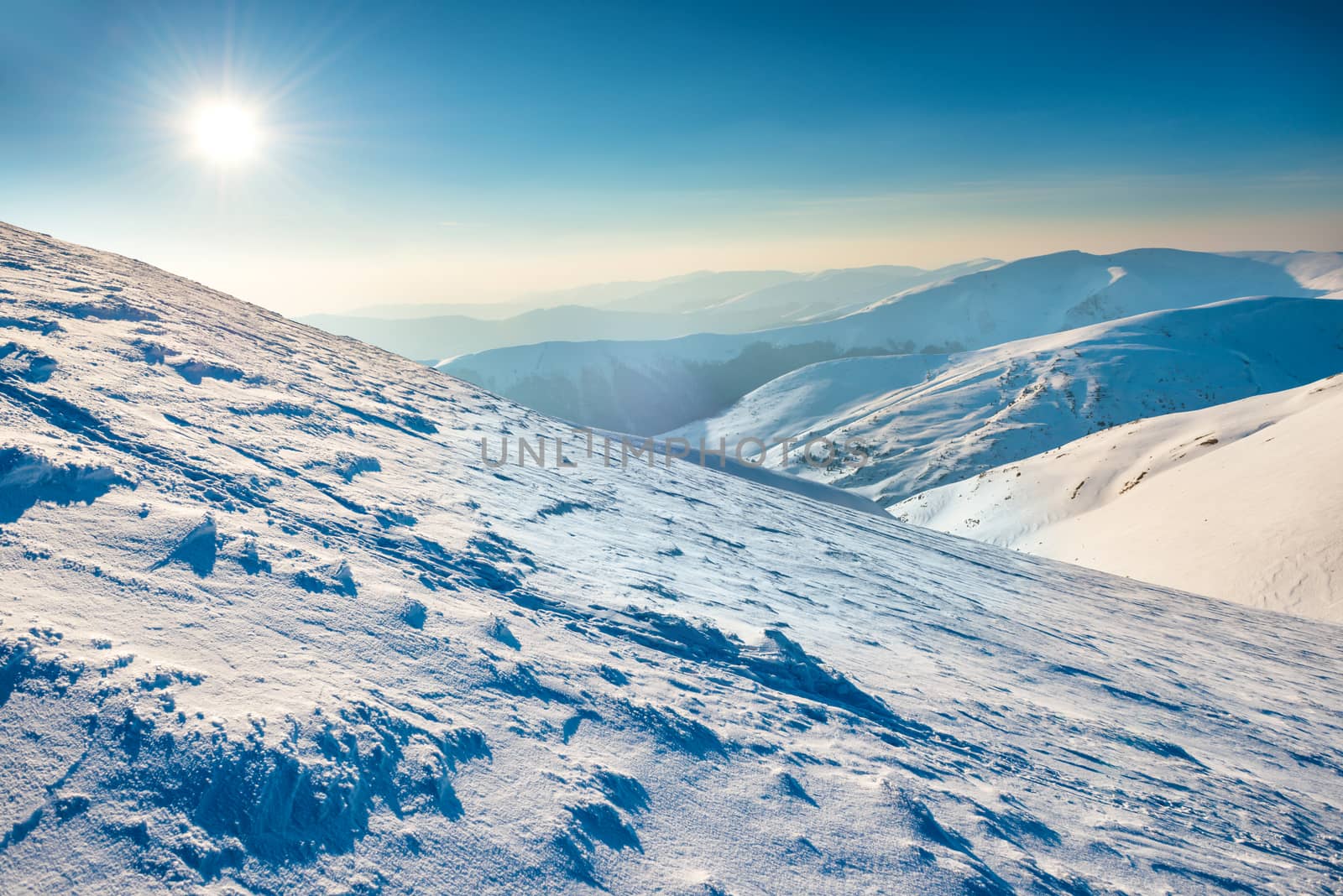 Bright sun in winter mountains covered with snow