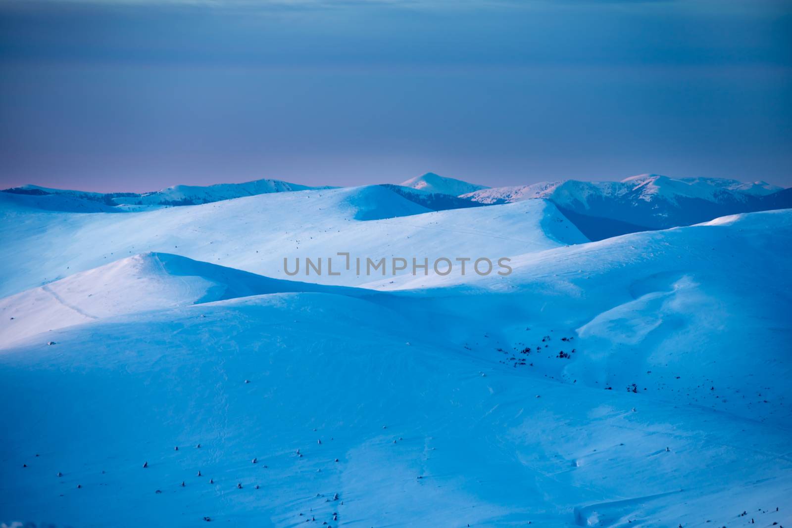 Sunset in winter mountains covered with snow