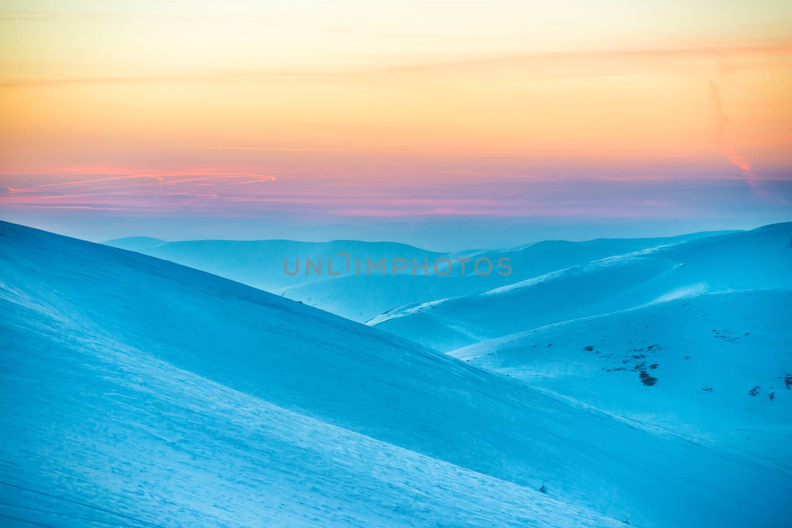 Sunset in winter mountains covered with snow