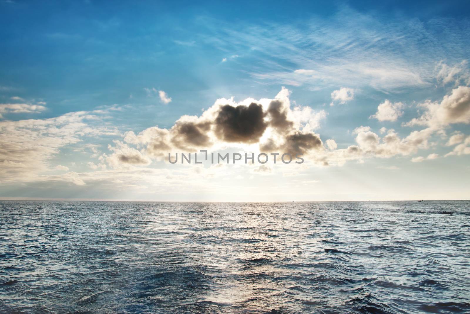 Sea with blue water, sky and clouds. Seascape