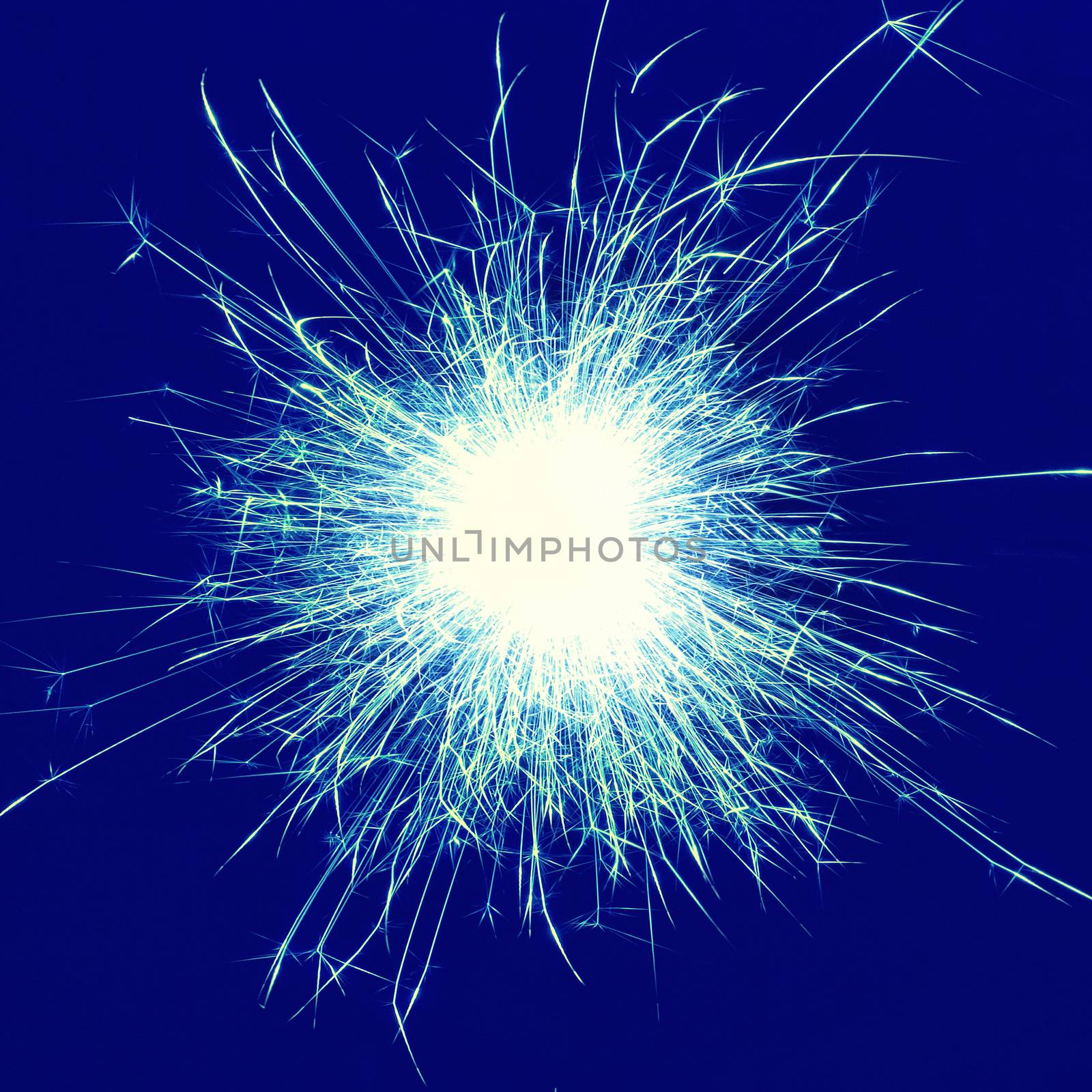 Blue holiday sparkle- fireworks on the black background. Instagram filter.