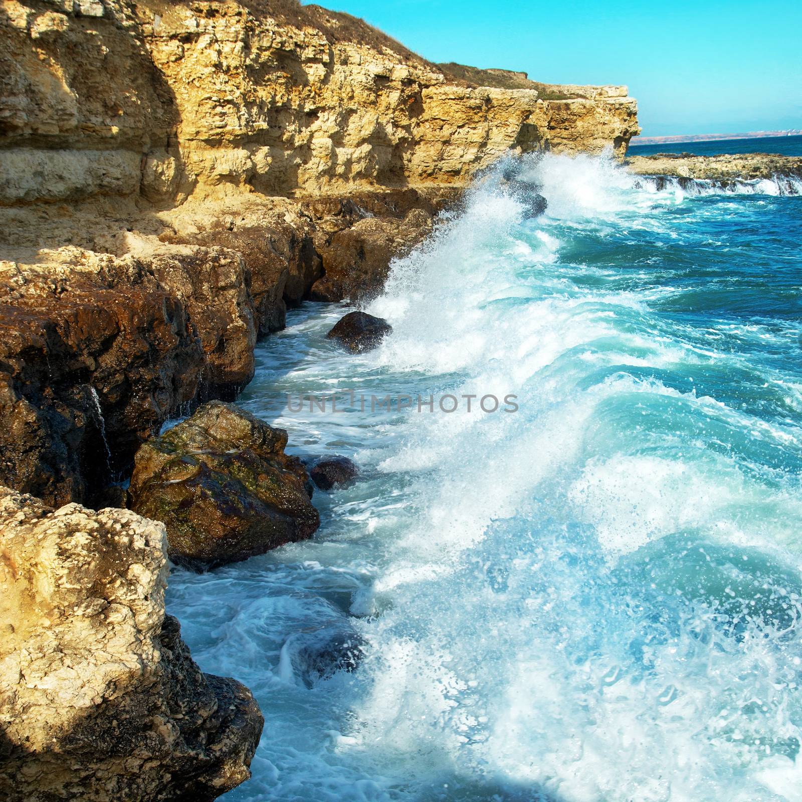 Big waves breaking on the shore with sea foam