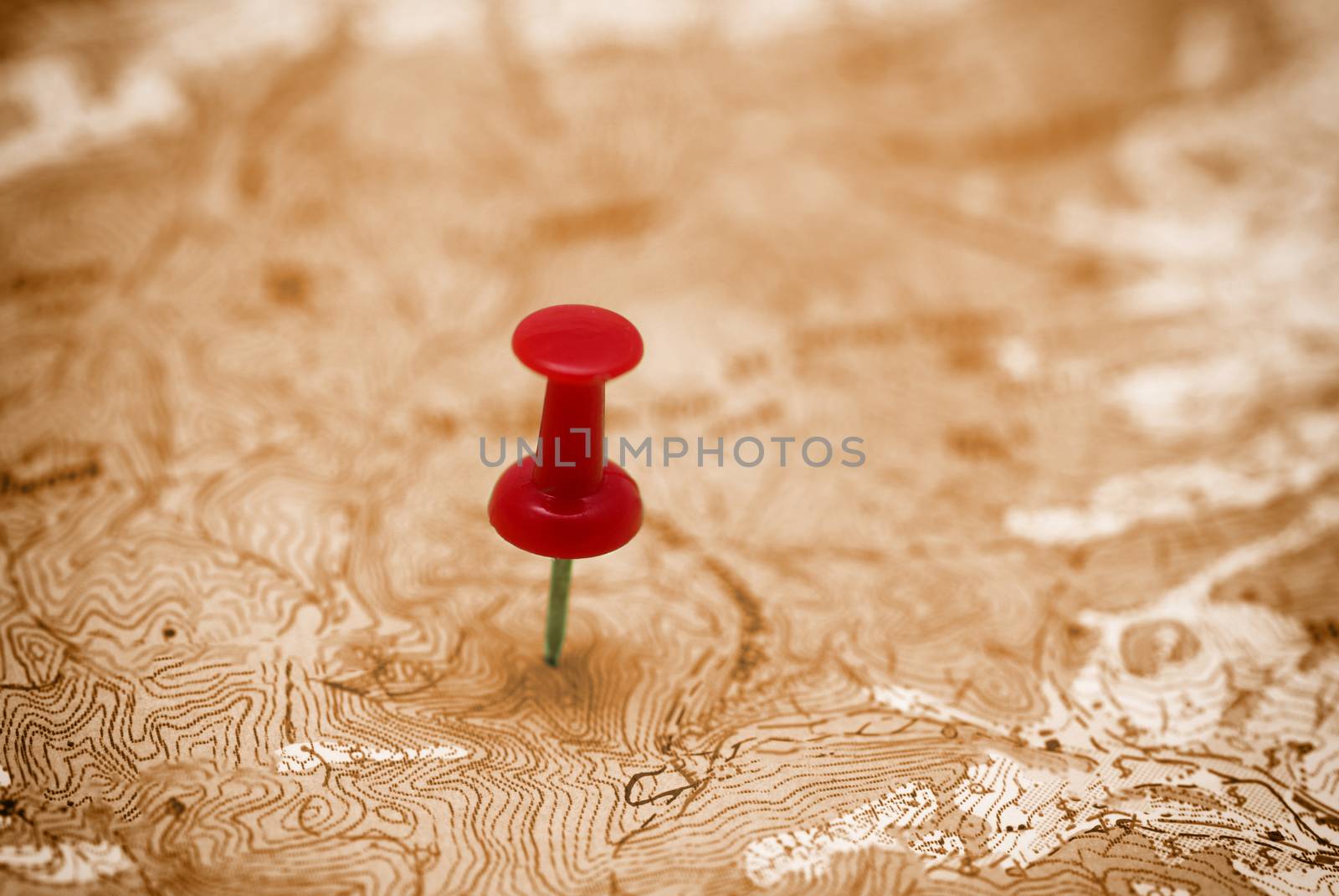 Red point on the old retro map- concept travel planning background