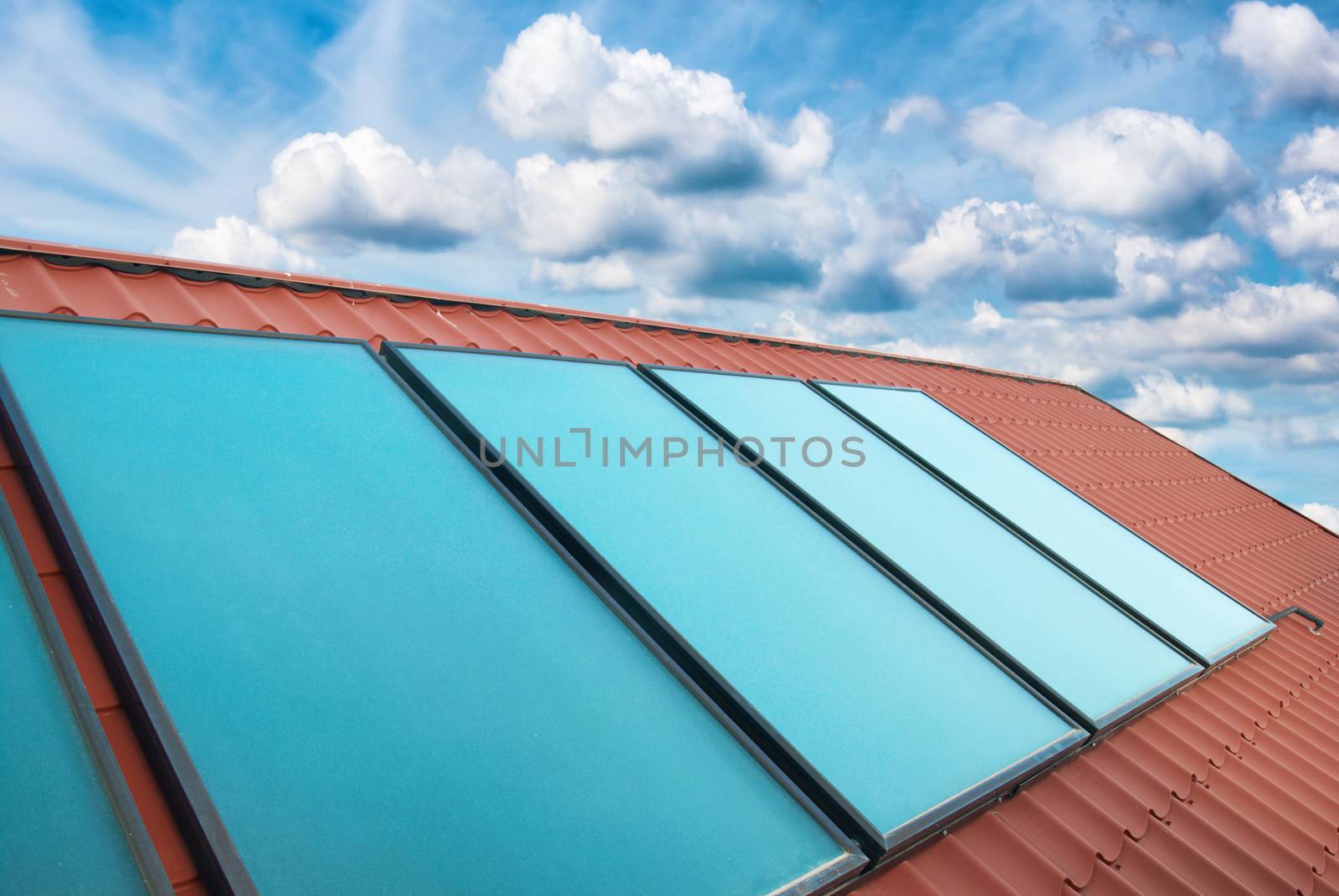 Solar cells on the red house roof by vapi