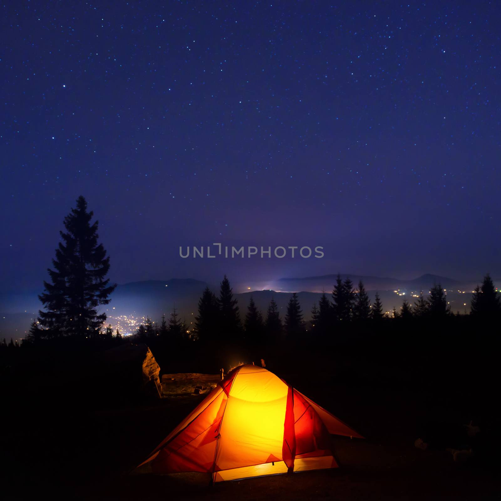 Illuminated orange camping tent by vapi
