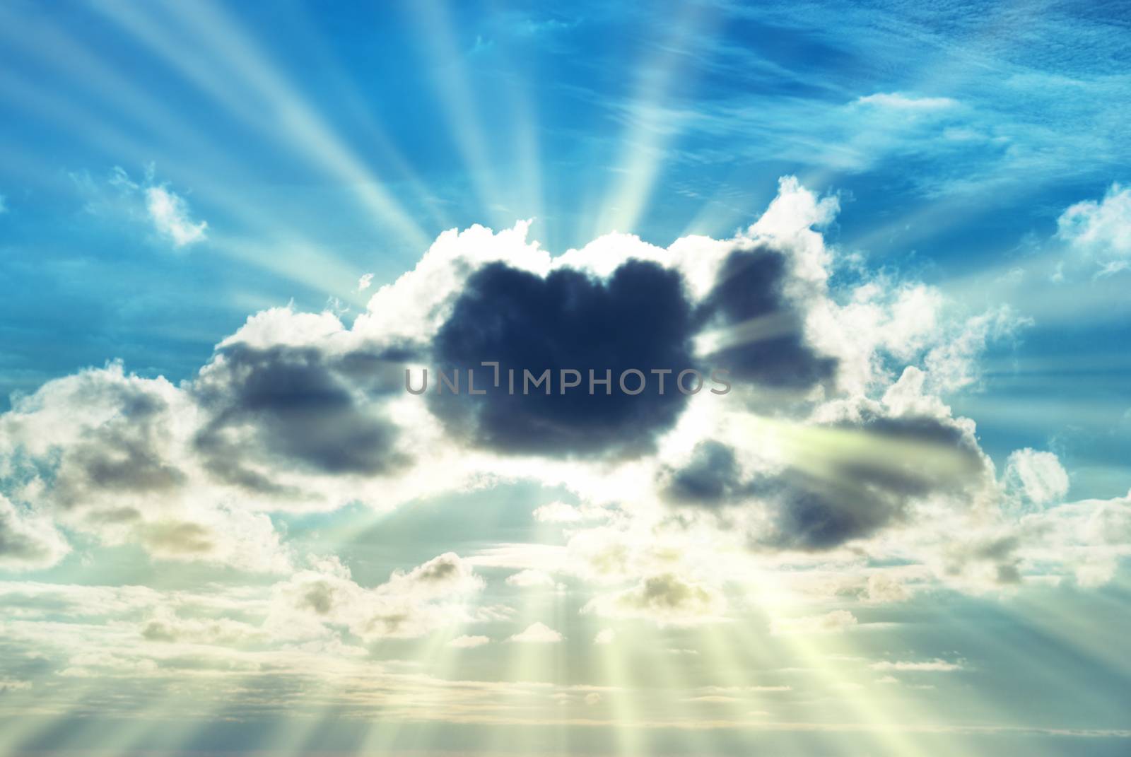 Beautiful blue sky with sunbeams and sun rays through the clouds.