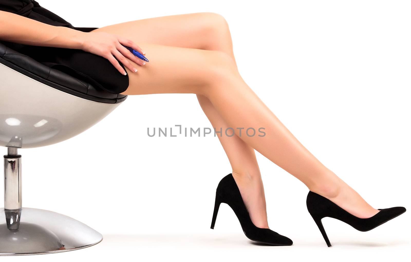 Woman with long legs sitting in a chair, isolated on white background