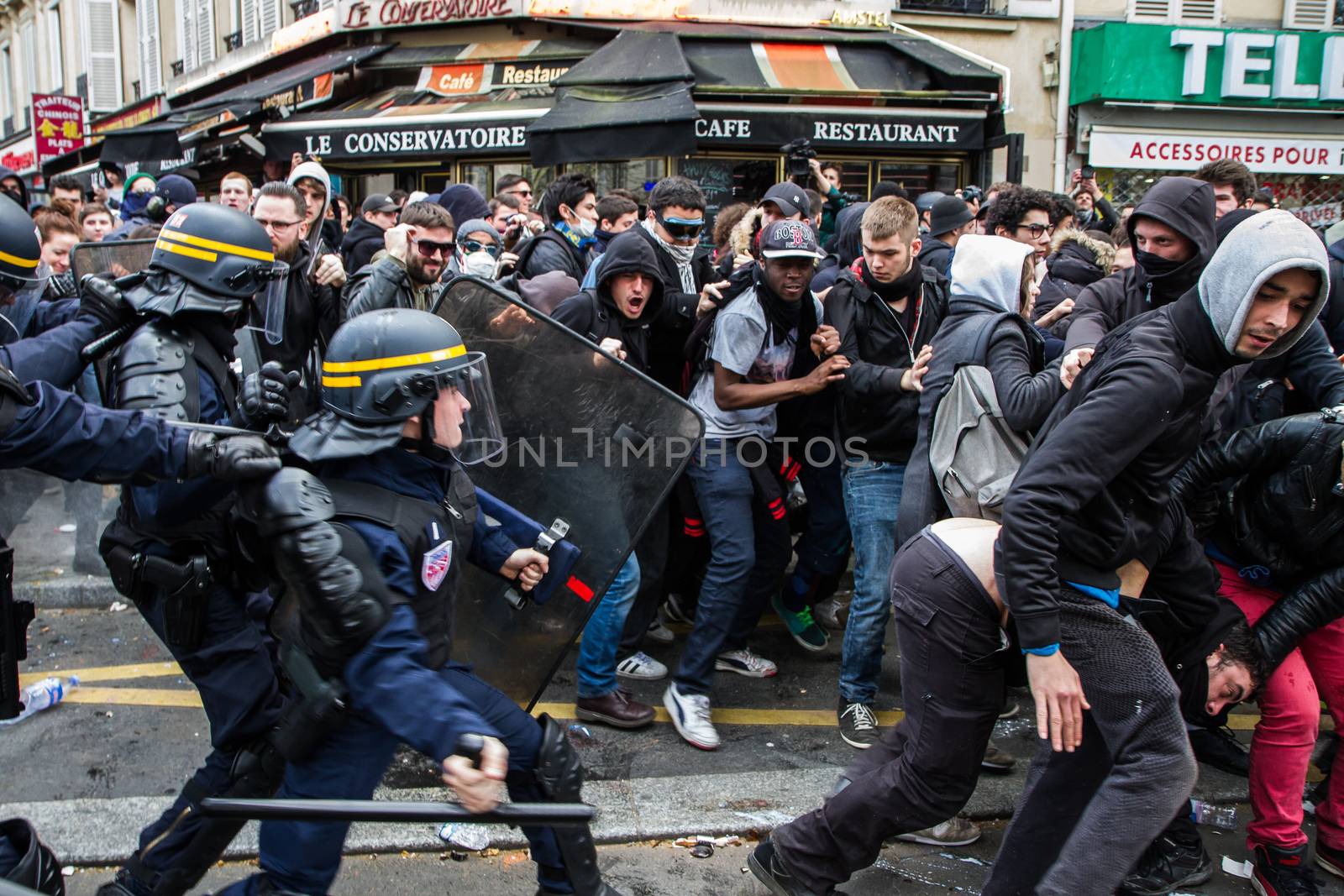 FRANCE, Paris: Riot policemen try to scatter a crowd of protesters as hundreds demonstrate against the French government's proposed labour law reforms on April 14, 2016 in Paris. Fresh strikes by unions and students are being held across France against proposed reforms to France's labour laws, heaping pressure on President Francois Hollande who suffered a major defeat over constitutional reforms on March 30.