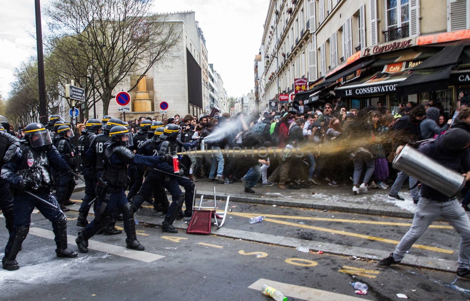 FRANCE, Paris: Riot policemen throw tear gas at protesters as hundreds demonstrate against the French government's proposed labour law reforms on April 14, 2016 in Paris. Fresh strikes by unions and students are being held across France against proposed reforms to France's labour laws, heaping pressure on President Francois Hollande who suffered a major defeat over constitutional reforms on March 30.