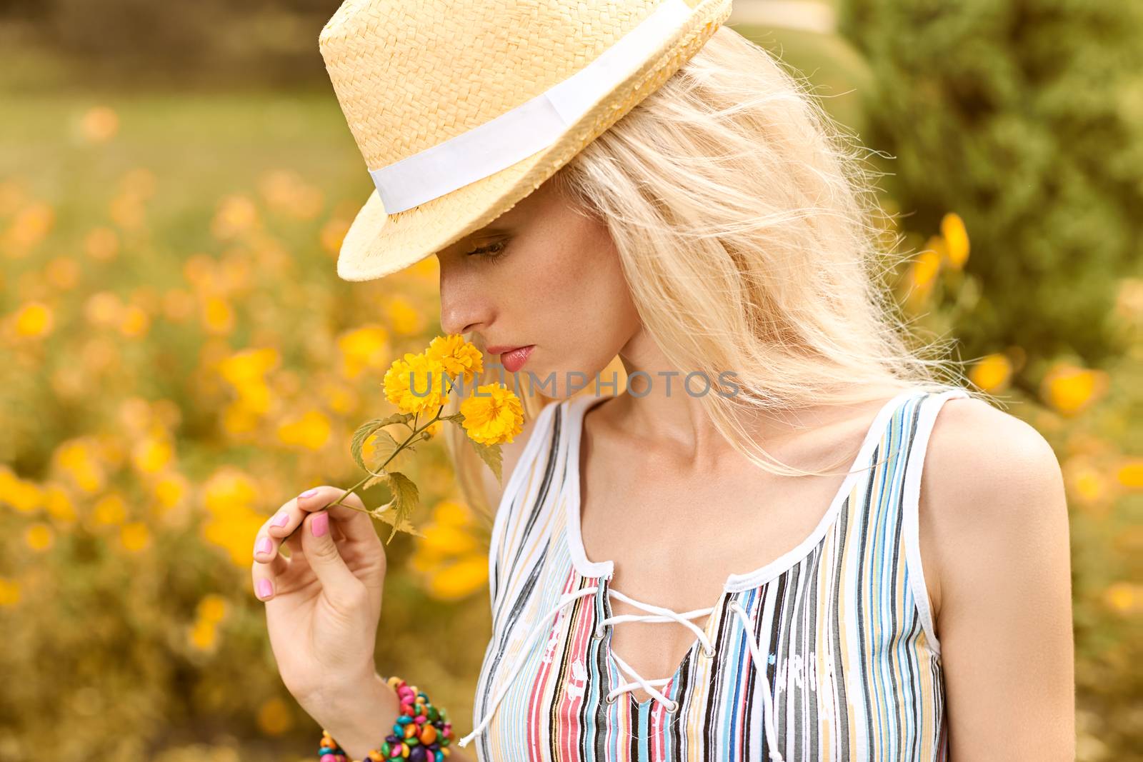 Beauty playful woman relax in summer garden dreaming, people, outdoors, bokeh. Attractive happy blonde girl in hat with flower enjoying nature, harmony on meadow, lifestyle.Sunny day, forest,copyspace