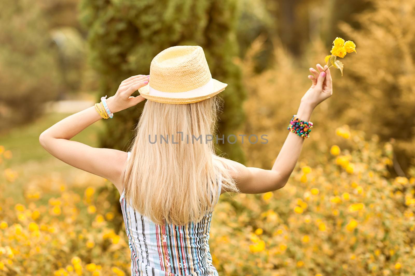 Beauty playful woman relax in summer garden dreaming, people, outdoors, bokeh. Attractive happy blonde girl in hat with flower enjoying nature, harmony on meadow, lifestyle.Sunny day, forest,copyspace