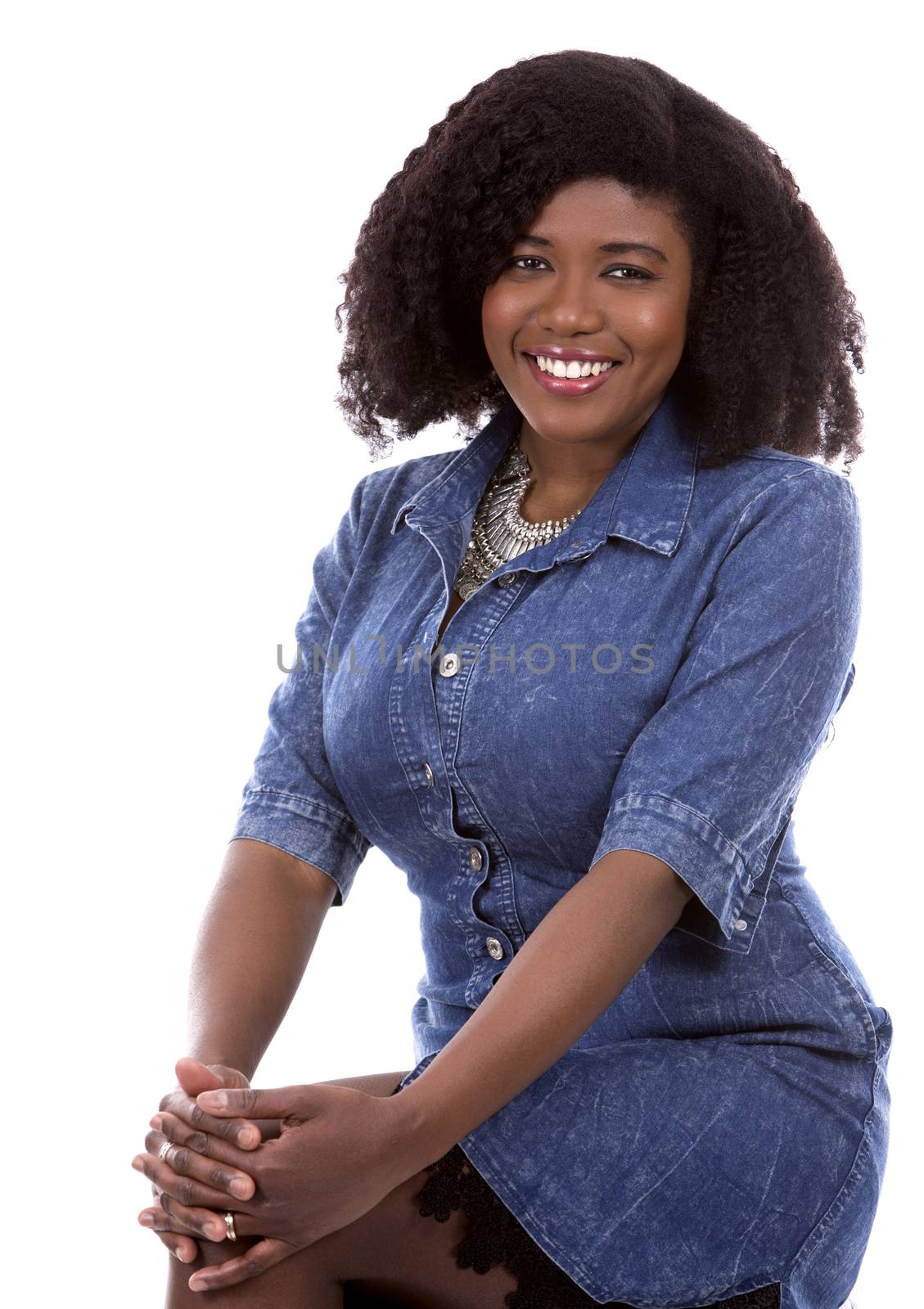 beautiful young black woman is wearing jean dress on white background