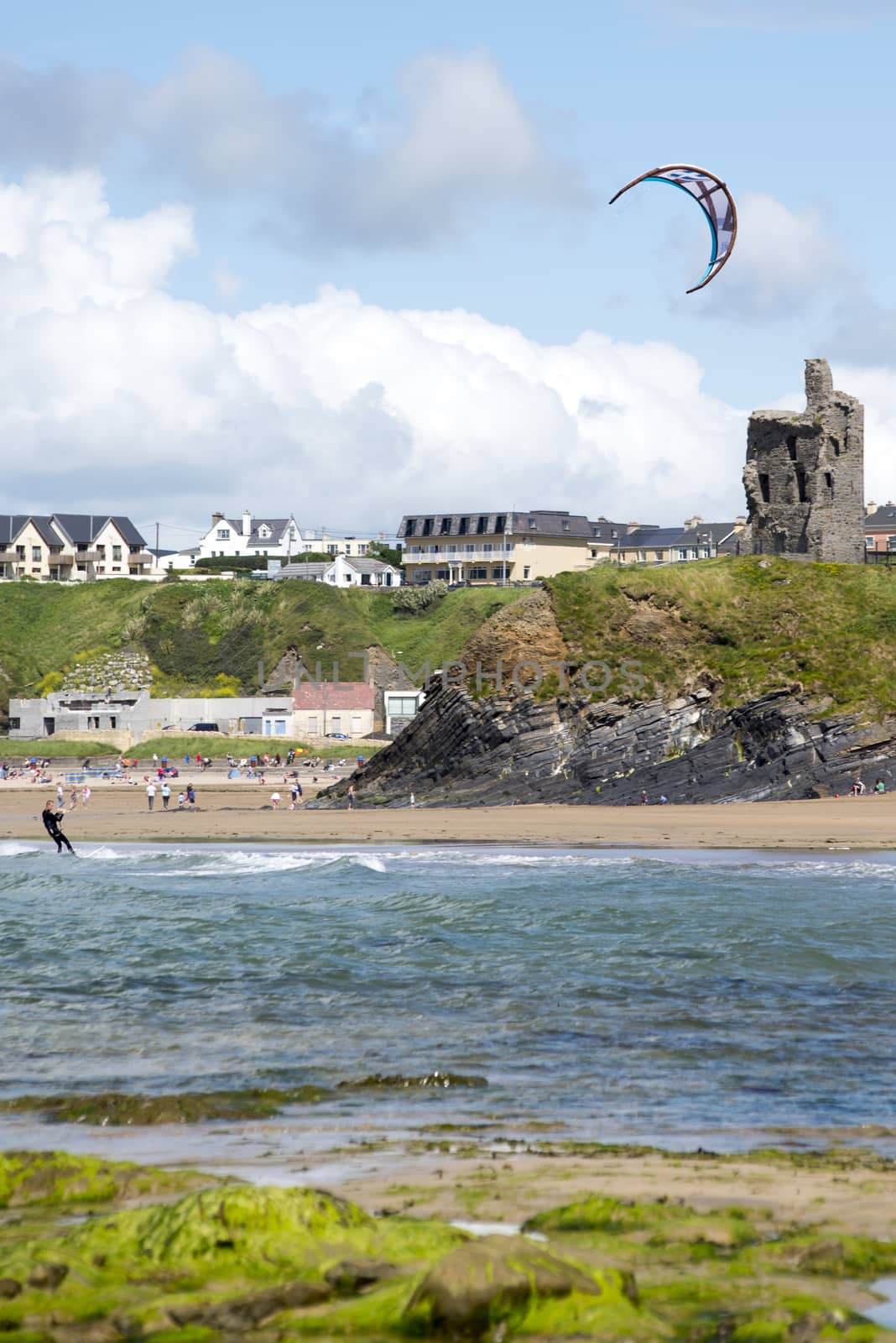 lone kite surfer playing the waves by morrbyte