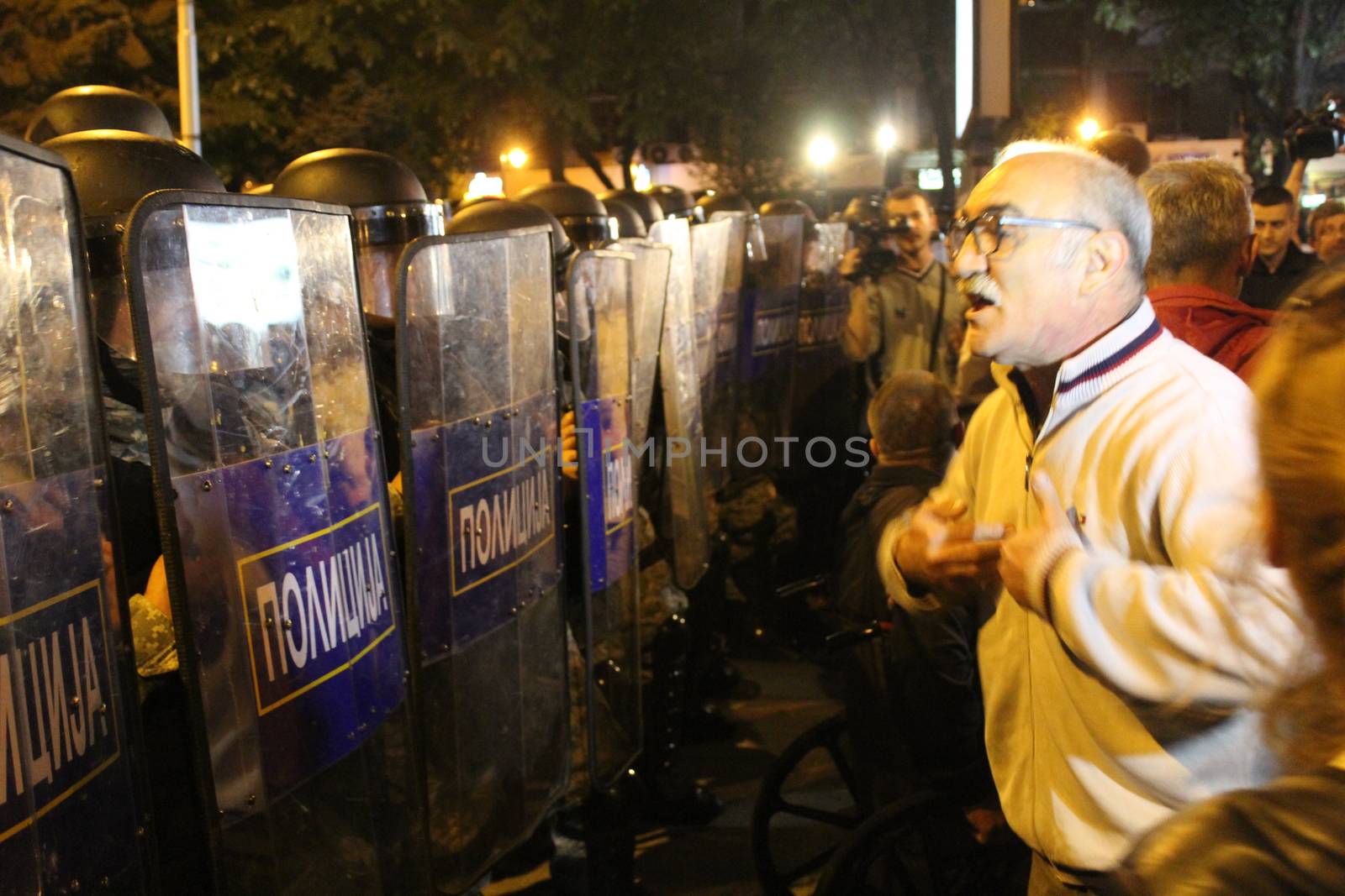 MACEDONIA, Skopje: A man faces riot police officers as thousands took to the streets of the Macedonian capital for a third consecutive evening to protest against the president's surprising decision to halt probes into more than 50 public figures embroiled in a wiretapping scandal in Skopje, on April 14, 2016. Similar anti-government protests in the capital had turned violent on Wednesday, when demonstrators ransacked the offices used by President Gjorge Ivanov, and set fire to the furniture.