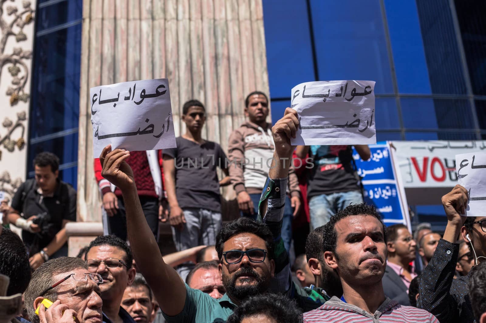 EGYPT, Cairo: People chant slogans and hold signs during a protest against the decision to hand over control of two strategic Red Sea islands, namely Tiran and Sanafir, to Saudi Arabia, in front of the Syndicate of Journalists building, in Cairo, on April 15, 2016.