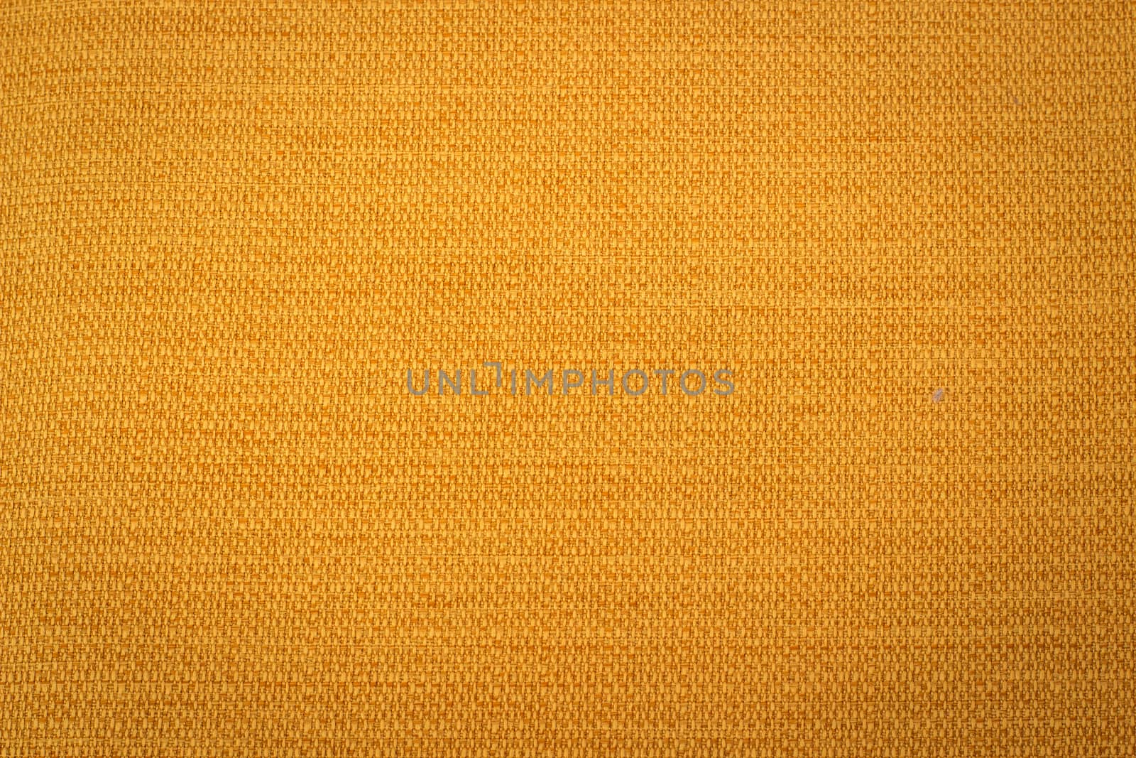 Rustic canvas fabric texture in yellow color.