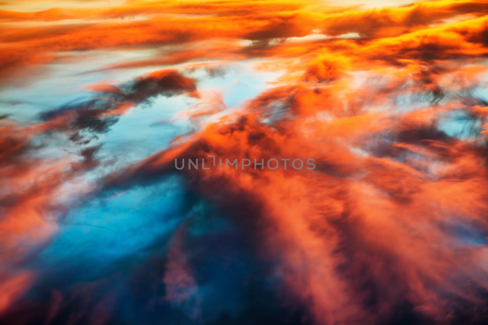 Aerial view to colorful orange and blue dramatic sky with clouds for abstract background