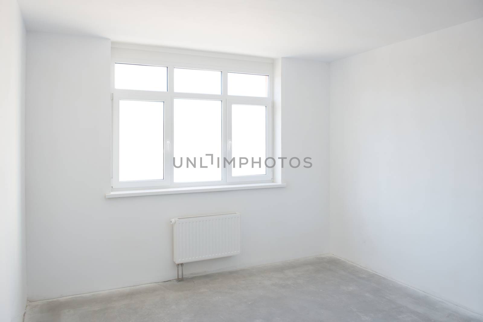 Empty white room with window full of light