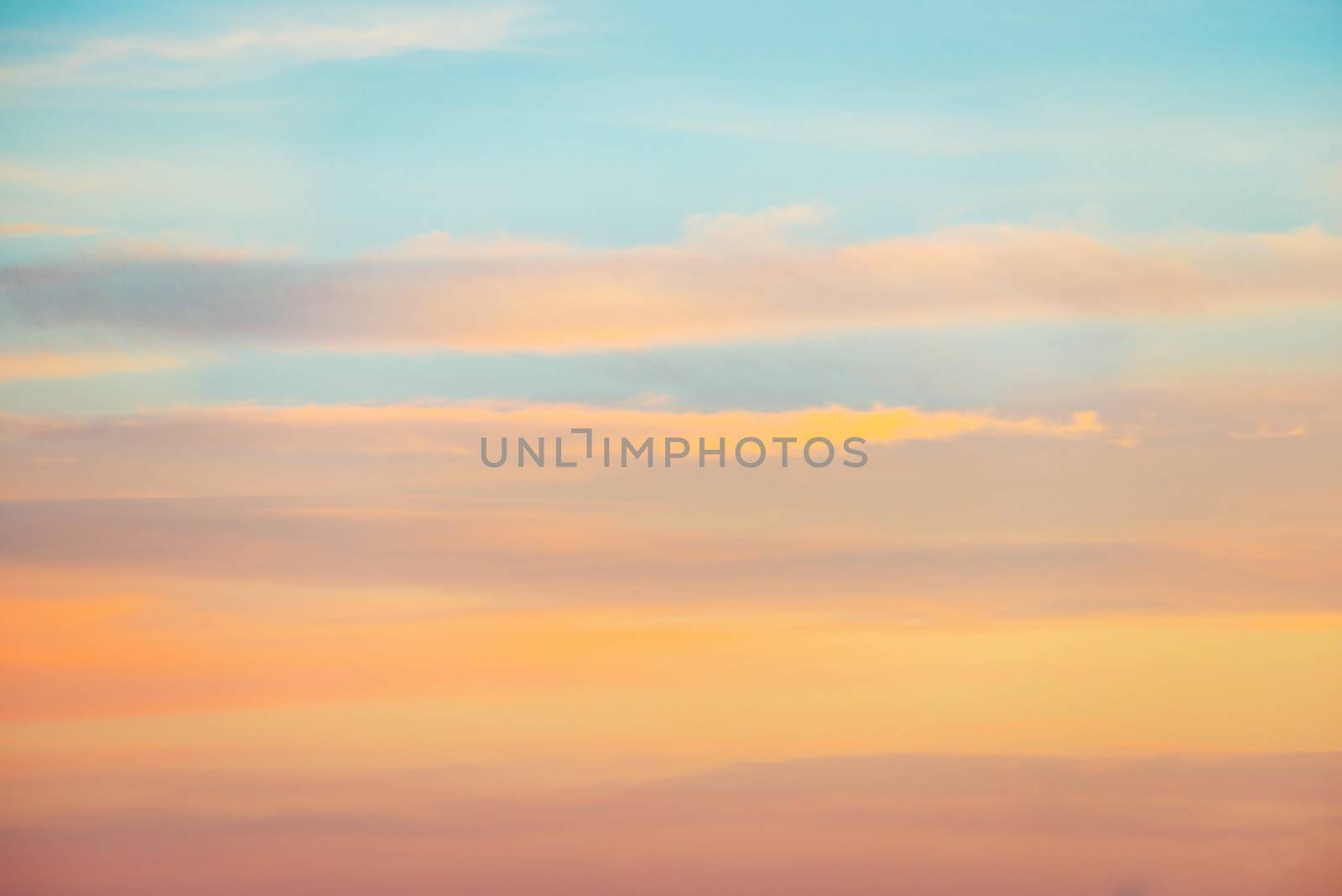 Pale sunset sky with pink, orange and red colors by vapi