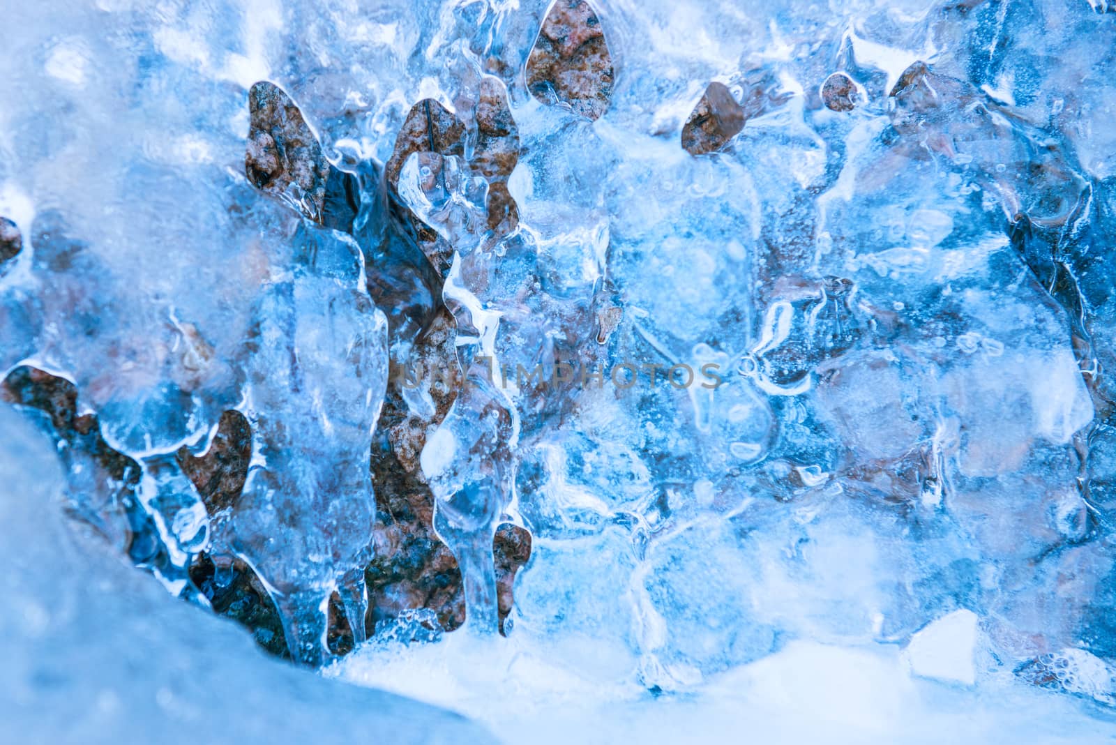 Frozen waterfall in blue ice. Winter background