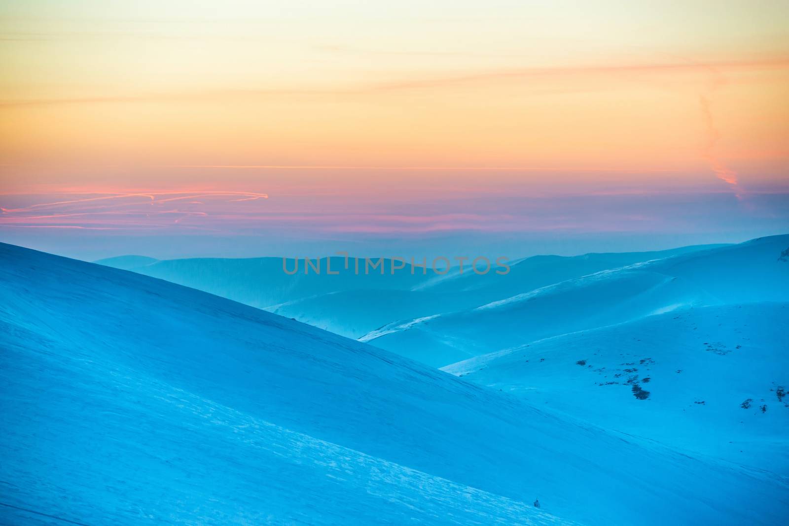 Sunset in winter mountains covered with snow