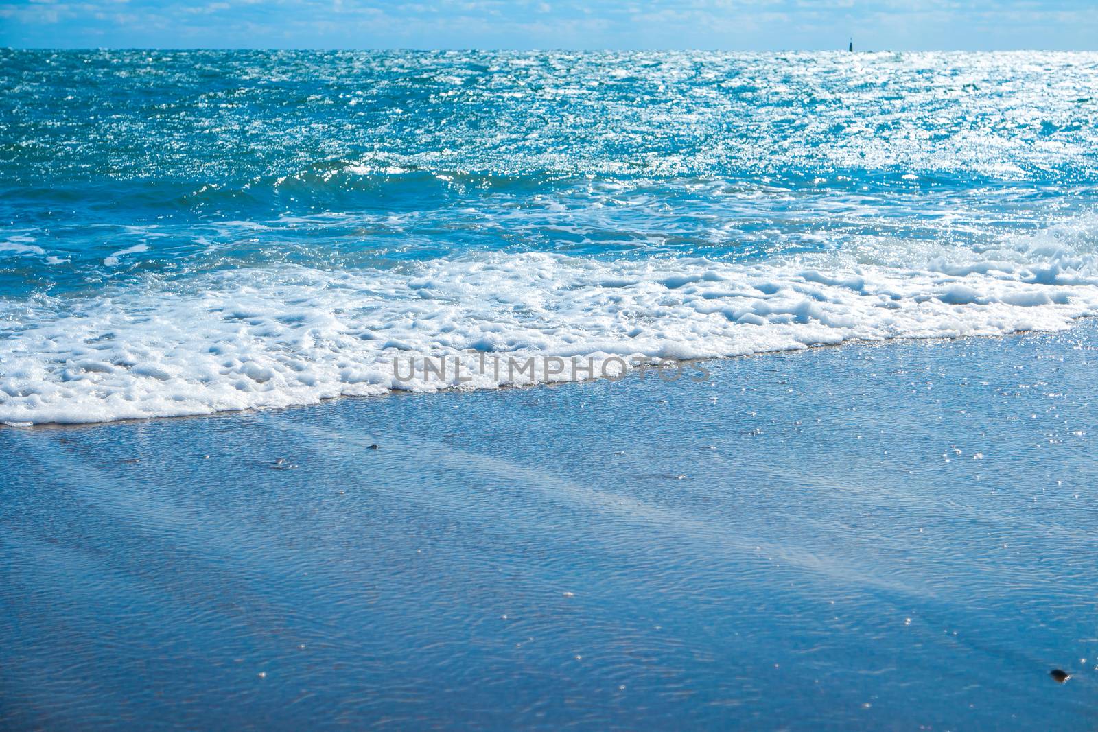 Blue sea and beach with golden sand by vapi