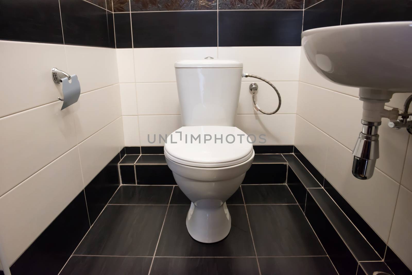 Interior of room at home flush toilet with bowl and sink.