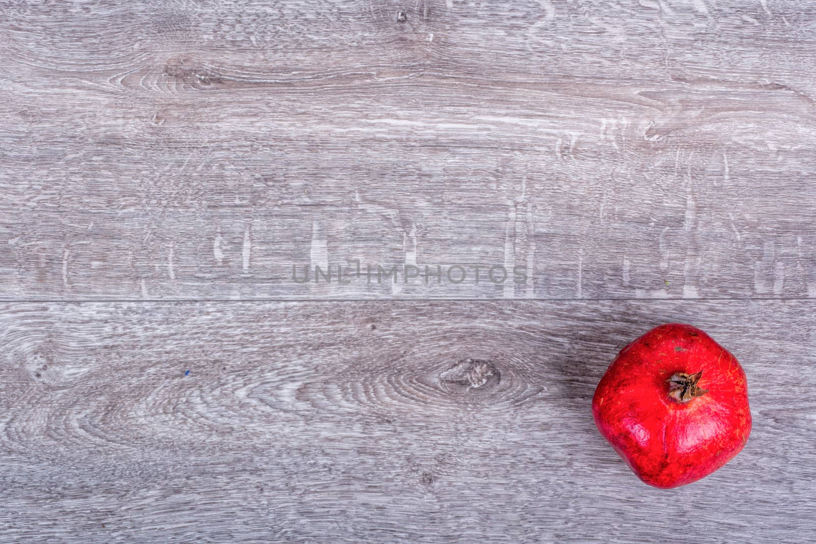 Red pomegranate on a wooden background