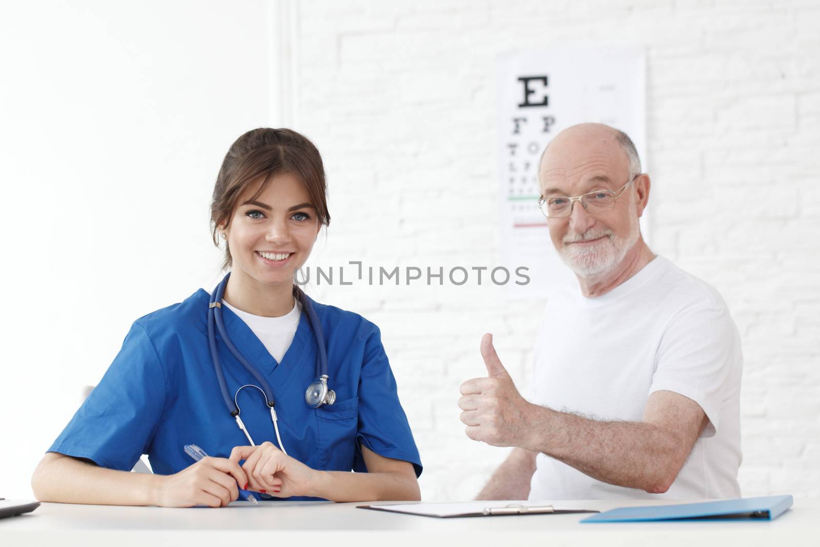 Happy senior patient with new glasses in ophthalmologist office